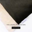 A close up detail of the corner of a Charley Chau Dog Snuggle Bed and dog Burrow Bag Dog Bed Cover with black outer cover in upholstery-quality Velour and plush cream faux-fur lining with a woven brand label showing the Charley Chau logo on a white backdrop.
