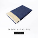 A folded spare dog bed cover to fit Charley Chau Snuggle Dog Beds and Dog Burrow Bags with dark navy blue outer cover in woven wool texture upholstery-quality Faroe and plush cream faux-fur lining on a white backdrop.