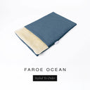 A folded spare dog bed cover to fit Charley Chau Snuggle Dog Beds and Dog Burrow Bags with deep teal blue outer cover in woven wool texture upholstery-quality Faroe and plush cream faux-fur lining on a white backdrop.