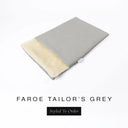 A folded spare dog bed cover to fit Charley Chau Snuggle Dog Beds and Dog Burrow Bags with light grey outer cover in woven wool texture upholstery-quality Faroe and plush cream faux-fur lining on a white backdrop.