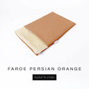 A folded spare dog bed cover to fit Charley Chau Snuggle Dog Beds and Dog Burrow Bags with terracotta orange outer cover in woven wool texture upholstery-quality Faroe and plush cream faux-fur lining on a white backdrop.
