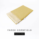 A folded spare dog bed cover to fit Charley Chau Snuggle Dog Beds and Dog Burrow Bags with golden yellow outer cover in woven wool texture upholstery-quality Faroe and plush cream faux-fur lining on a white backdrop.