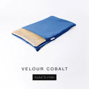 A folded spare dog bed cover to fit Charley Chau Snuggle Dog Beds and Dog Burrow Bags with bright cobalt blue outer cover in upholstery-quality Velour and plush cream faux-fur lining on a white backdrop.