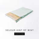 A folded spare dog bed cover to fit Charley Chau Snuggle Dog Beds and Dog Burrow Bags with pale mint green outer cover in upholstery-quality Velour and plush cream faux-fur lining on a white backdrop.