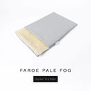 A folded spare dog bed cover to fit Charley Chau Snuggle Dog Beds and Dog Burrow Bags with pale grey outer cover in woven wool texture upholstery-quality Faroe and plush cream faux-fur lining on a white backdrop.