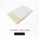 A folded spare dog bed cover to fit Charley Chau Snuggle Dog Beds and Dog Burrow Bags with pale cream outer cover in woven wool texture upholstery-quality Faroe and plush cream faux-fur lining on a white backdrop.