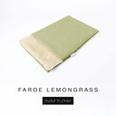 A folded spare dog bed cover to fit Charley Chau Snuggle Dog Beds and Dog Burrow Bags with soft olive green outer cover in woven wool texture upholstery-quality Faroe and plush cream faux-fur lining on a white backdrop.