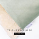 A close up detail of the corner of a Charley Chau Dog Snuggle Bed and dog Burrow Bag Dog Bed Cover with pale sage green outer cover in upholstery-quality Velour and plush cream faux-fur lining with a woven brand label showing the Charley Chau logo on a white backdrop.