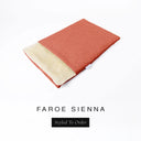 A folded spare dog bed cover to fit Charley Chau Snuggle Dog Beds and Dog Burrow Bags with coral orange outer cover in woven wool texture upholstery-quality Faroe and plush cream faux-fur lining on a white backdrop.