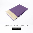 A folded spare dog bed cover to fit Charley Chau Snuggle Dog Beds and Dog Burrow Bags with dusty purple outer cover in woven wool texture upholstery-quality Faroe and plush cream faux-fur lining on a white backdrop.