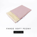 A folded spare dog bed cover to fit Charley Chau Snuggle Dog Beds and Dog Burrow Bags with pale dusty pink outer cover in woven wool texture upholstery-quality Faroe and plush cream faux-fur lining on a white backdrop.