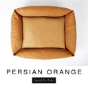 Top-down view of the Bliss Bolster Dog Bed in a warm amber orange 'PERSIAN ORANGE' Faroe fabric, showing the raised sides and deep cushioned base of this long lasting dog bed with sides; a comfortable bolster dog bed and high-wall dog bed for everyday use.