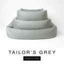 Three sizes of the Bliss Bolster Dog Bed in a classic mid grey 'TAILOR'S GREY' Faroe fabric nested together, showing this long lasting dog bed with sides in Small, Medium and Large; a hard-wearing bolster dog bed and high-wall dog bed for everyday comfort.