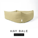Close-up corner view of a warm golden oat Bliss Bolster Dog Bed in 'HAY BALE' Faroe fabric with a black 'Styled To Order' label, showing the tall walls of this long lasting dog bed with sides; a durable bolster dog bed and high-wall dog bed built to last.