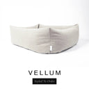 Close-up corner view of a soft off-white cream Bliss Bolster Dog Bed in 'VELLUM' Faroe fabric with a black 'Styled To Order' label, showing the tall walls of this long lasting dog bed with sides; a durable bolster dog bed and high-wall dog bed built to last.