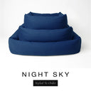 Three sizes of the Bliss Bolster Dog Bed in a deep navy blue 'NIGHT SKY' Faroe fabric nested together, showing this long lasting dog bed with sides in Small, Medium and Large; a hard-wearing bolster dog bed and high-wall dog bed for everyday comfort.