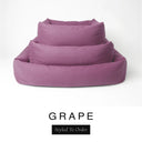 Three sizes of the Bliss Bolster Dog Bed in a dusky mauve-purple 'GRAPE' Faroe fabric nested together, showing this long lasting dog bed with sides in Small, Medium and Large; a hard-wearing bolster dog bed and high-wall dog bed for everyday comfort.