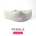 Close-up corner view of a warm stone grey Bliss Bolster Dog Bed in 'PEBBLE' Faroe fabric with a pink 'Core Collection' label, showing the tall walls of this long lasting dog bed with sides; a durable bolster dog bed and high-wall dog bed built to last.