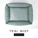 Top-down view of the Bliss Bolster Dog Bed in a muted sage teal 'TEAL MIST' Faroe fabric, showing the raised sides and deep cushioned base of this long lasting dog bed with sides; a comfortable bolster dog bed and high-wall dog bed for everyday use.