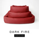 Three sizes of the Bliss Bolster Dog Bed in a deep rust red 'DARK FIRE' Faroe fabric nested together, showing this long lasting dog bed with sides in Small, Medium and Large; a hard-wearing bolster dog bed and high-wall dog bed for everyday comfort.
