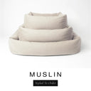 Three sizes of the Bliss Bolster Dog Bed in a soft warm cream 'MUSLIN' Faroe fabric nested together, showing this long lasting dog bed with sides in Small, Medium and Large; a hard-wearing bolster dog bed and high-wall dog bed for everyday comfort.
