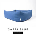 Close-up corner view of a rich denim blue Bliss Bolster Dog Bed in 'CAPRI BLUE' Faroe fabric with a black 'Styled To Order' label, showing the tall walls of this long lasting dog bed with sides; a durable bolster dog bed and high-wall dog bed built to last.