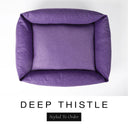Top-down view of the Bliss Bolster Dog Bed in a rich deep purple 'DEEP THISTLE' Faroe fabric, showing the raised sides and deep cushioned base of this long lasting dog bed with sides; a comfortable bolster dog bed and high-wall dog bed for everyday use.