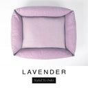 Top-down view of the Bliss Bolster Dog Bed in a soft dusky pink-lilac 'LAVENDER' Faroe fabric, showing the raised sides and deep cushioned base of this long lasting dog bed with sides; a comfortable bolster dog bed and high-wall dog bed for everyday use.