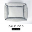 Top-down view of the Bliss Bolster Dog Bed in a soft pale grey 'PALE FOG' Faroe fabric, showing the raised sides and deep cushioned base of this long lasting dog bed with sides; a comfortable bolster dog bed and high-wall dog bed for everyday use.