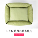 Top-down view of the Bliss Bolster Dog Bed in a soft sage green 'LEMONGRASS' Faroe fabric, showing the raised sides and deep cushioned base of this long lasting dog bed with sides; a comfortable bolster dog bed and high-wall dog bed for everyday use.
