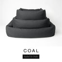 Three sizes of the Bliss Bolster Dog Bed in a dark charcoal black 'COAL' Faroe fabric nested together, showing this long lasting dog bed with sides in Small, Medium and Large; a hard-wearing bolster dog bed and high-wall dog bed for everyday comfort.