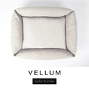 Top-down view of the Bliss Bolster Dog Bed in a soft off-white cream 'VELLUM' Faroe fabric, showing the raised sides and deep cushioned base of this long lasting dog bed with sides; a comfortable bolster dog bed and high-wall dog bed for everyday use.