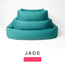 Three sizes of the Bliss Bolster Dog Bed in a deep teal green 'JADE' Faroe fabric nested together, showing this long lasting dog bed with sides in Small, Medium and Large; a hard-wearing bolster dog bed and high-wall dog bed for everyday comfort.