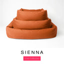Three sizes of the Bliss Bolster Dog Bed in a warm burnt orange 'SIENNA' Faroe fabric nested together, showing this long lasting dog bed with sides in Small, Medium and Large; a hard-wearing bolster dog bed and high-wall dog bed for everyday comfort.