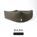 Close-up corner view of a deep olive brown Bliss Bolster Dog Bed in 'BARK' Faroe fabric with a black 'Styled To Order' label, showing the tall walls of this long lasting dog bed with sides; a durable bolster dog bed and high-wall dog bed built to last.