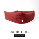 Close-up corner view of a deep rust red Bliss Bolster Dog Bed in 'DARK FIRE' Faroe fabric with a black 'Styled To Order' label, showing the tall walls of this long lasting dog bed with sides; a durable bolster dog bed and high-wall dog bed built to last.