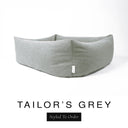 Close-up corner view of a classic mid grey Bliss Bolster Dog Bed in 'TAILOR'S GREY' Faroe fabric with a black 'Styled To Order' label, showing the tall walls of this long lasting dog bed with sides; a durable bolster dog bed and high-wall dog bed built to last.