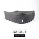 Close-up corner view of a dark charcoal grey Bliss Bolster Dog Bed in 'BASALT' Faroe fabric with a black 'Styled To Order' label, showing the tall walls of this long lasting dog bed with sides; a durable bolster dog bed and high-wall dog bed built to last.