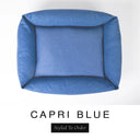 Top-down view of the Bliss Bolster Dog Bed in a rich denim blue 'CAPRI BLUE' Faroe fabric, showing the raised sides and deep cushioned base of this long lasting dog bed with sides; a comfortable bolster dog bed and high-wall dog bed for everyday use.