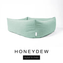 Close-up corner view of a pale sage green Bliss Bolster Dog Bed in 'HONEYDEW' Faroe fabric with a black 'Styled To Order' label, showing the tall walls of this long lasting dog bed with sides; a durable bolster dog bed and high-wall dog bed built to last.