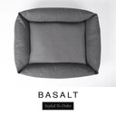 Top-down view of the Bliss Bolster Dog Bed in a dark charcoal grey 'BASALT' Faroe fabric, showing the raised sides and deep cushioned base of this long lasting dog bed with sides; a comfortable bolster dog bed and high-wall dog bed for everyday use.