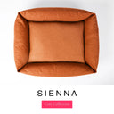 Top-down view of the Bliss Bolster Dog Bed in a warm burnt orange 'SIENNA' Faroe fabric, showing the raised sides and deep cushioned base of this long lasting dog bed with sides; a comfortable bolster dog bed and high-wall dog bed for everyday use.