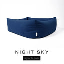 Close-up corner view of a deep navy blue Bliss Bolster Dog Bed in 'NIGHT SKY' Faroe fabric with a black 'Styled To Order' label, showing the tall walls of this long lasting dog bed with sides; a durable bolster dog bed and high-wall dog bed built to last.