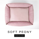 Top-down view of the Bliss Bolster Dog Bed in a soft blush pink 'SOFT PEONY' Faroe fabric, showing the raised sides and deep cushioned base of this long lasting dog bed with sides; a comfortable bolster dog bed and high-wall dog bed for everyday use.