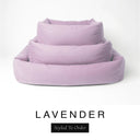 Three sizes of the Bliss Bolster Dog Bed in a soft dusky pink-lilac 'LAVENDER' Faroe fabric nested together, showing this long lasting dog bed with sides in Small, Medium and Large; a hard-wearing bolster dog bed and high-wall dog bed for everyday comfort.