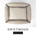 Top-down view of the Bliss Bolster Dog Bed in a warm sandy taupe 'DRIFTWOOD' Faroe fabric, showing the raised sides and deep cushioned base of this long lasting dog bed with sides; a comfortable bolster dog bed and high-wall dog bed for everyday use.