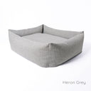 A luxury box style dog bed in grey, The Bliss Bolster Dog Bed by Charley Chau, a long-lasting dog bed made with a durable and hard-wearing upholstery fabric on a white backdrop.  