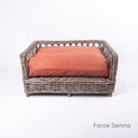 Charley Chau's stylish Raised Rattan Dog Bed with deep-filled luxury dog bed mattress in orange on a white backdrop.