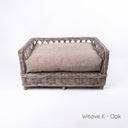 Charley Chau's stylish Raised Rattan Dog Bed with deep-filled luxury dog bed mattress in beige on a white  backdrop.