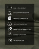 A fabric swatch of tough, water-resitant dog bed fabric in olive green dry wax cotton canvas with a black rectangular informational panel with white icons and text listing the dog bed fabric product properties: machine washable, highly water-resistant, OEKO-TEX Standard 100, 100% cotton canvas, fabulous for mucky dogs, rugged & resilient, and all seasons use.